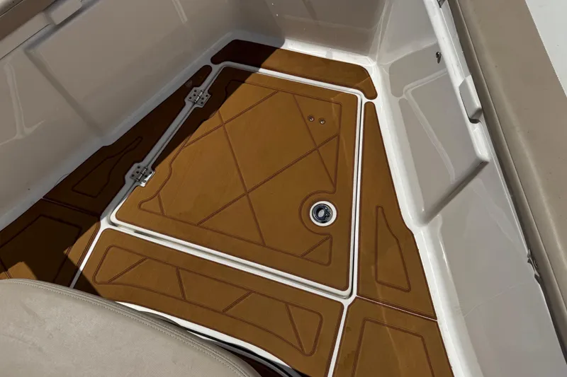 Slide: The Image of 2021 Robalo R242 Center Console boat deck with brown non-slip flooring. - 16