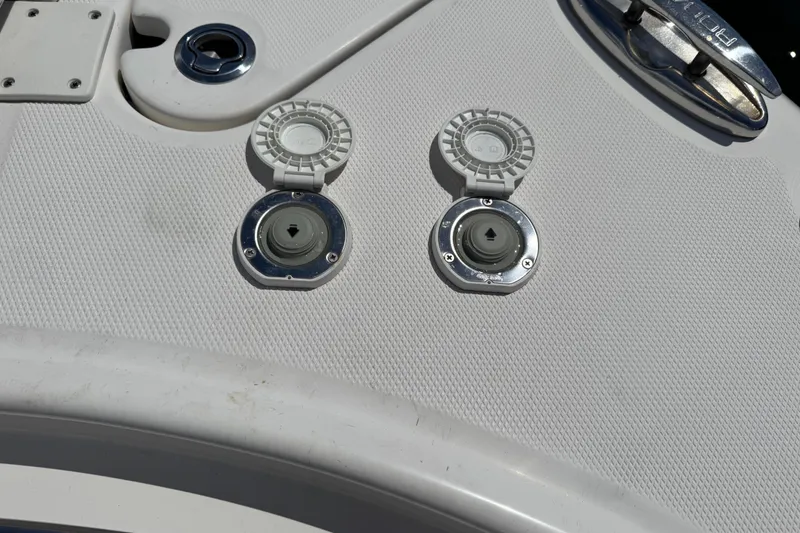 Slide: The Image of 2021 Robalo R242 Center Console boat deck with fuel and water fill caps. - 19