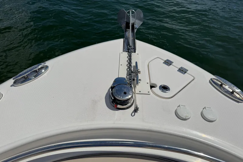 Slide: The Image of 2021 Robalo R242 Center Console boat bow with anchor and chain on water. - 20