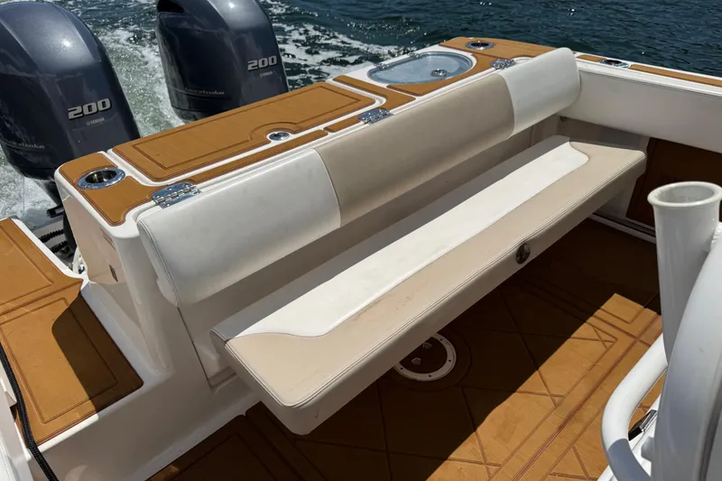 Slide: The Image of 2021 Robalo R242 Center Console boat with dual Yamaha 200 engines, featuring cushioned seating. - 9