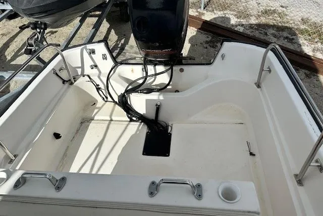 Slide: The Image of 1999 Boston Whaler 170 Montauk boat interior with outboard motor and railing. - 4