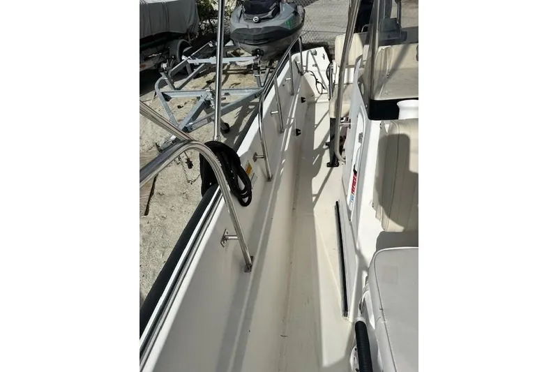 Slide: The Image of 1999 Boston Whaler 170 Montauk boat interior with seating and railing. - 9