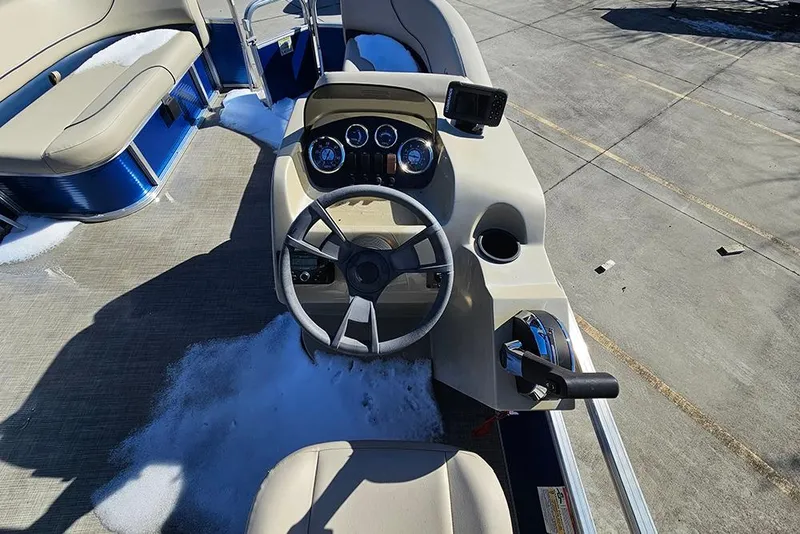 Slide: The Image of 2023 Lowe Ultra 180 Cruise boat dashboard with steering wheel and controls. - 12