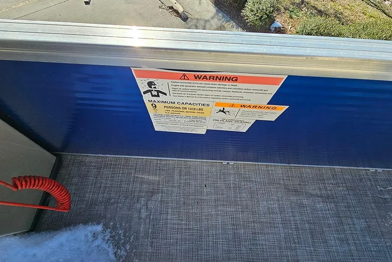Slide: The Image of Warning label on 2023 Lowe Ultra 180 Cruise boat, indicating maximum capacity of 9 persons. - 13