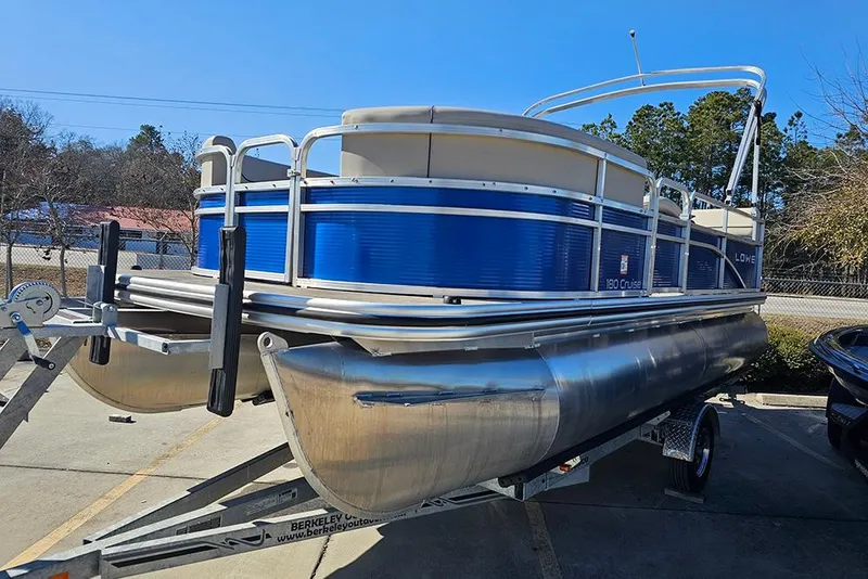 Slide: The Image of 2023 Lowe Ultra 180 Cruise pontoon boat on trailer, blue and silver design. - 6