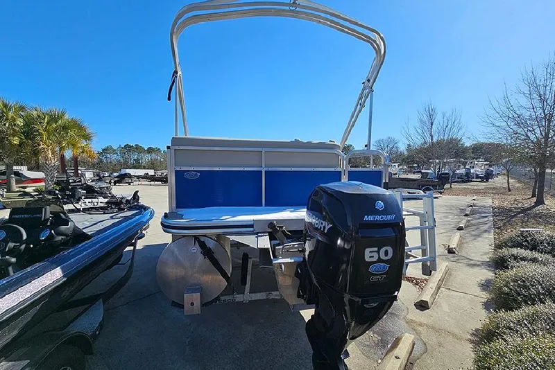 Slide: The Image of 2023 Lowe Ultra 180 Cruise pontoon boat with Mercury 60 HP engine in a sunny marina. - 7
