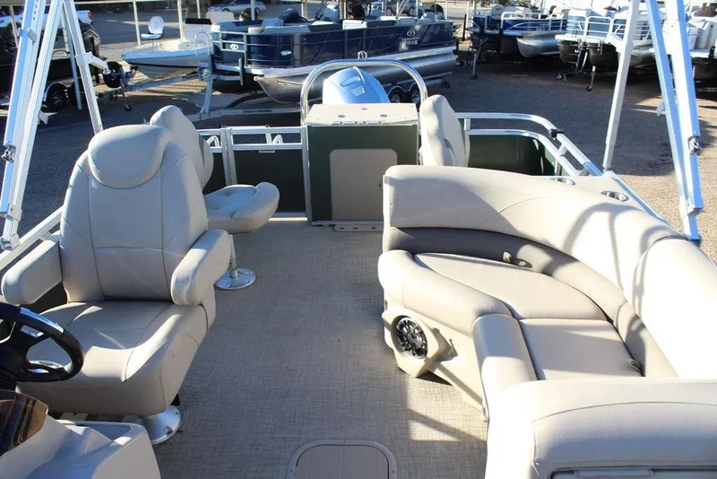 Slide: The Image of 2022 Avalon Venture Fish N Cruise 22 FT pontoon boat with beige seating and steering console. - 11