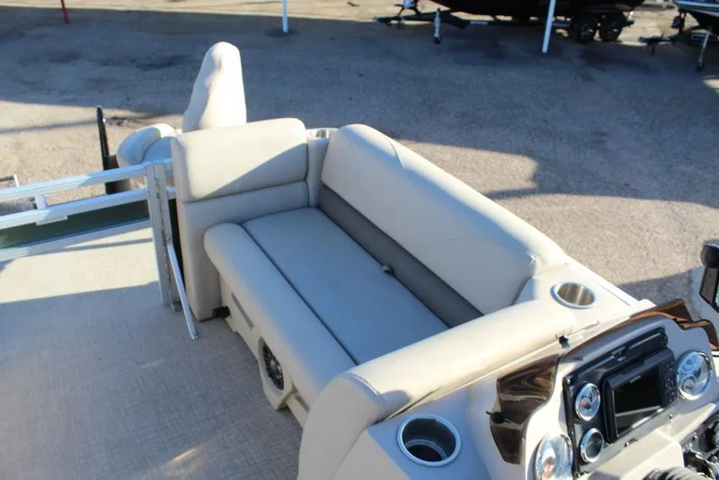 Slide: The Image of 2022 Avalon Venture Fish N Cruise 22 FT boat interior with beige seating and control panel. - 15