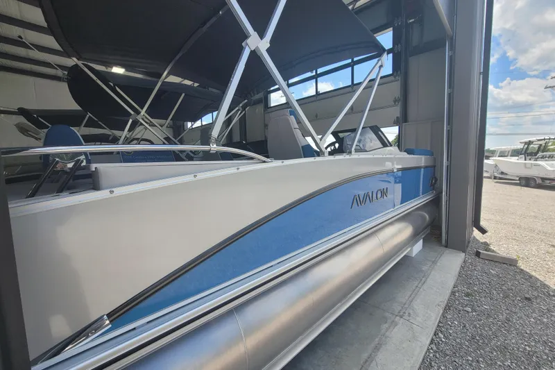 Slide: The Image of 2026 Avalon Platinum Catalina 2585 Windshield Cruise Rear Bench pontoon boat in storage. - 6
