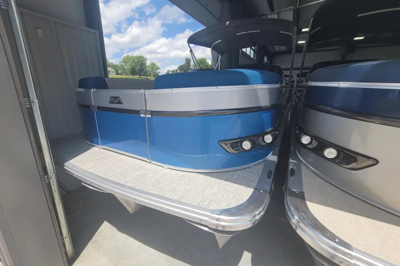 Slide: The Image of 2026 Avalon Platinum Catalina 2585 pontoon boat in storage, featuring a blue exterior. - 7