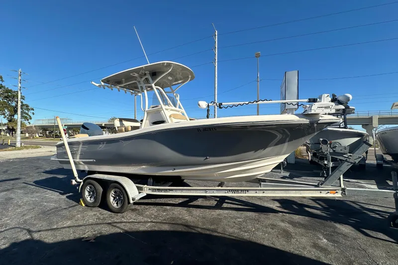 The Image of 2020 Pioneer 222 Sportfish boat on trailer under clear blue sky. - 0