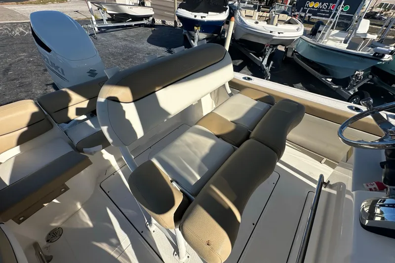 Slide: The Image of 2020 Pioneer 222 Sportfish boat interior with beige seating and steering wheel. - 10