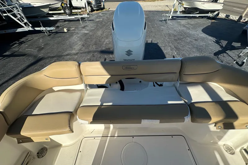 Slide: The Image of 2020 Pioneer 222 Sportfish boat interior with beige seating and Suzuki engine. - 15