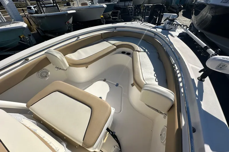Slide: The Image of 2020 Pioneer 222 Sportfish boat interior with cushioned seating and storage compartments. - 18