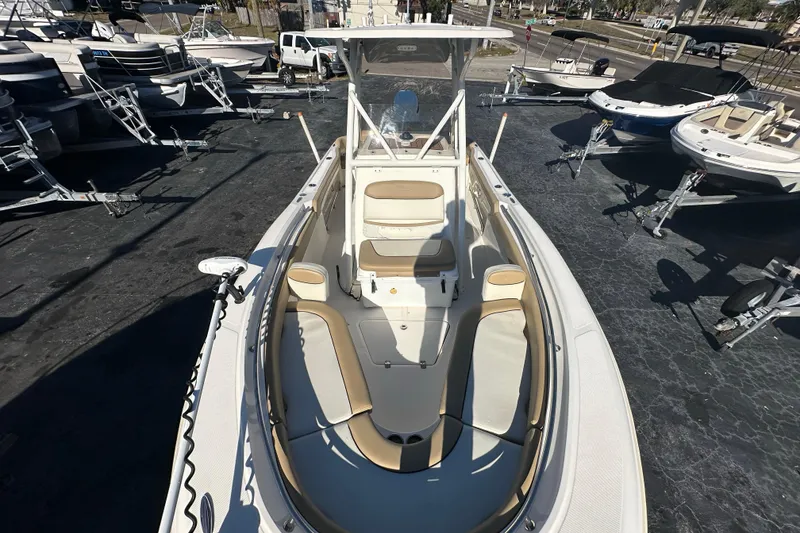 Slide: The Image of 2020 Pioneer 222 Sportfish boat with seating, parked among other boats. - 19