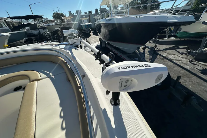 Slide: The Image of 2020 Pioneer 222 Sportfish boat with Minn Kota trolling motor in a marina. - 21