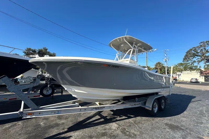 Slide: The Image of 2020 Pioneer 222 Sportfish boat on trailer under clear blue sky. - 6