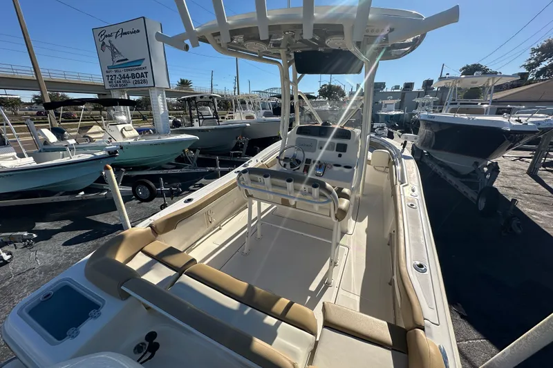 Slide: The Image of 2020 Pioneer 222 Sportfish boat at a dealership, showcasing interior and console. - 8