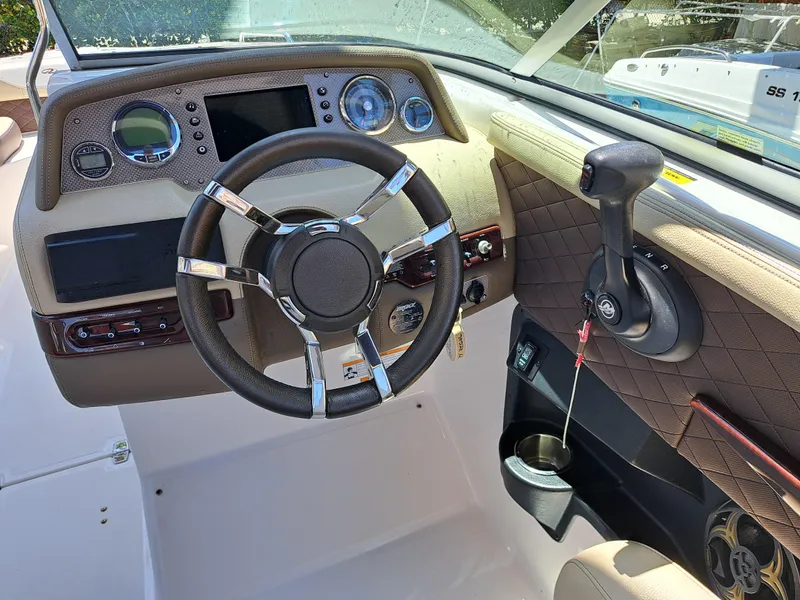Slide: The Image of 2014 Regal 2700 Bowrider dashboard with steering wheel and control panel. - 12