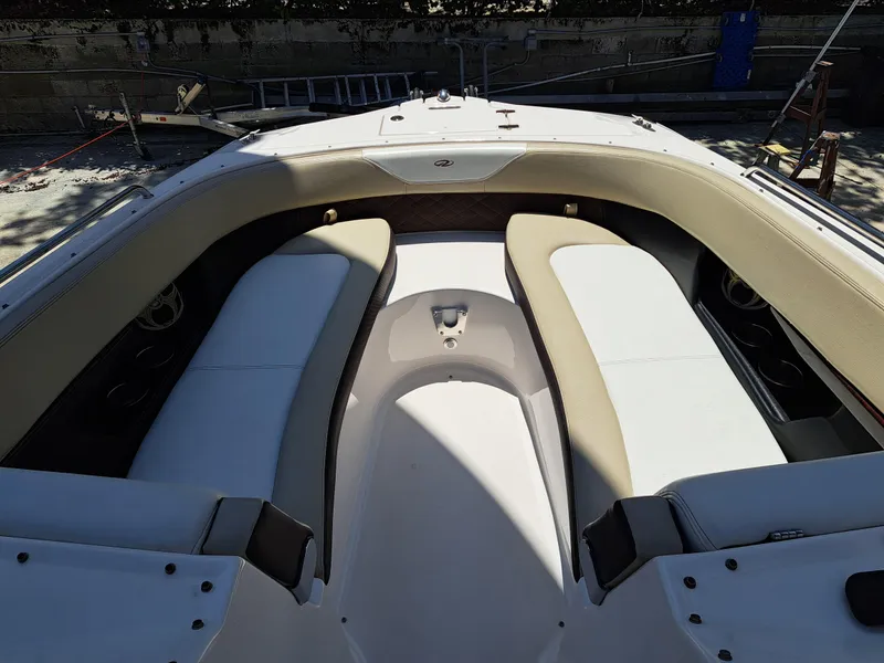 Slide: The Image of 2014 Regal 2700 Bowrider boat interior with white and beige seating. - 15