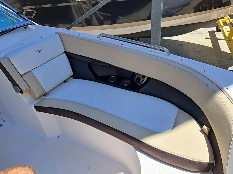 Slide: The Image of 2014 Regal 2700 Bowrider interior seating area with white and beige upholstery. - 16