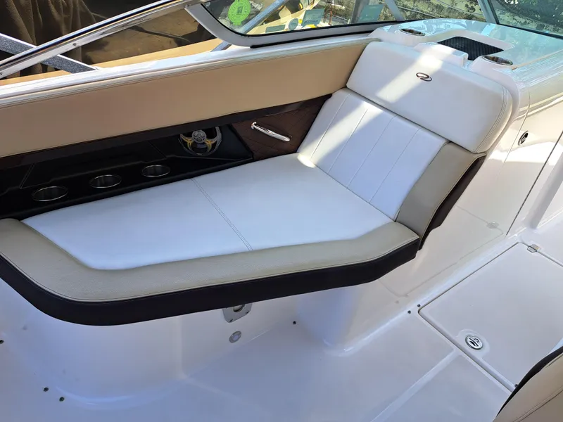 Slide: The Image of 2014 Regal 2700 Bowrider boat interior with white and beige seating. - 17