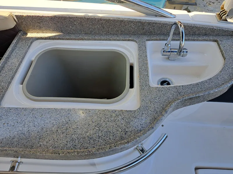 Slide: The Image of 2014 Regal 2700 Bowrider boat sink and countertop. - 23