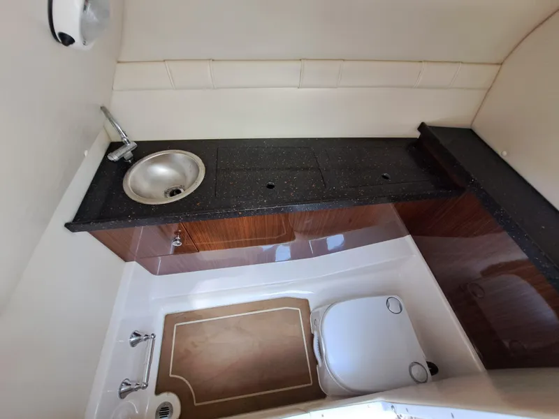 Slide: The Image of 2014 Regal 2700 Bowrider boat bathroom with sink and toilet. - 30