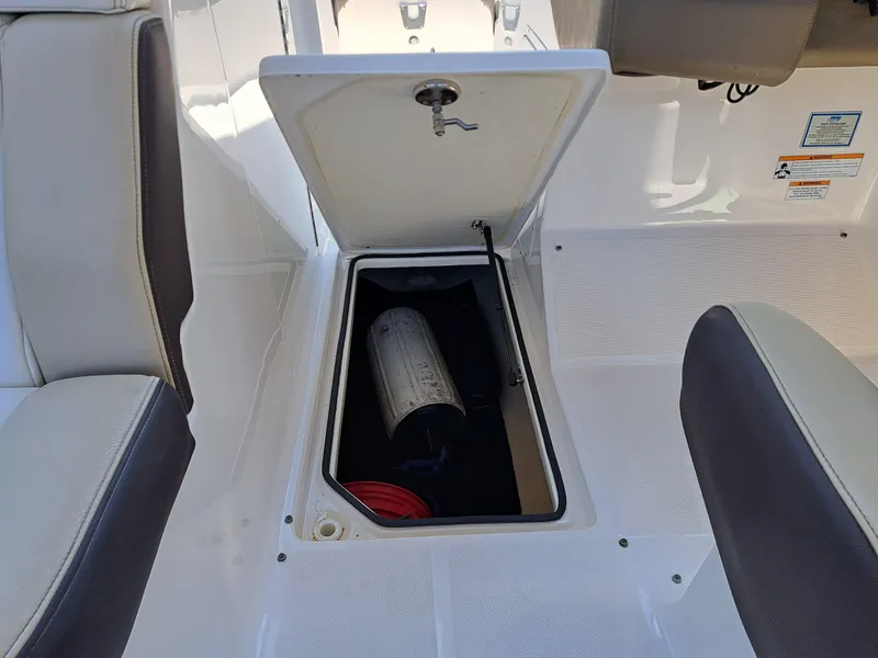 Slide: The Image of 2014 Regal 2700 Bowrider storage compartment with open hatch. - 34