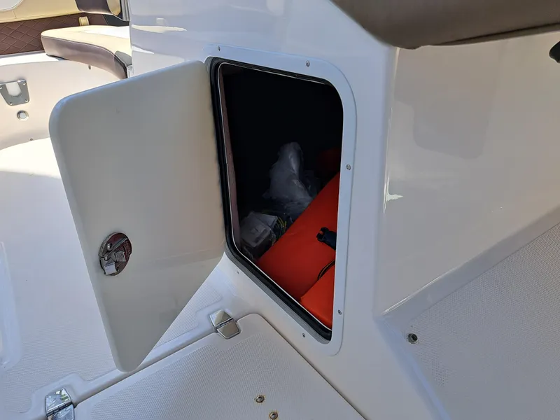 Slide: The Image of Open storage compartment on a 2014 Regal 2700 Bowrider boat. - 35