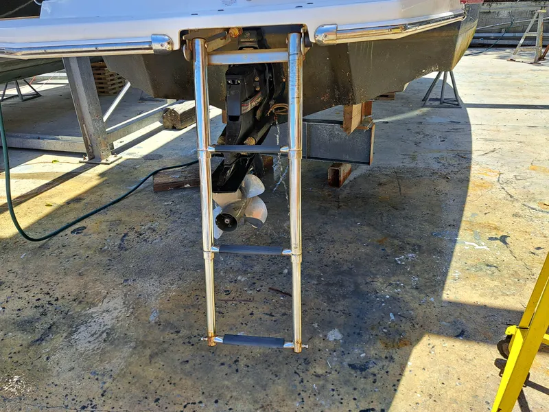 Slide: The Image of 2014 Regal 2700 Bowrider boat with extended swim ladder and propeller. - 38