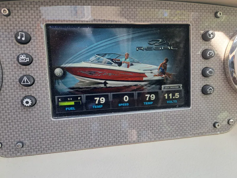 Slide: The Image of Dashboard display of a 2014 Regal 2700 Bowrider boat showing fuel, temperature, speed, and voltage. - 39