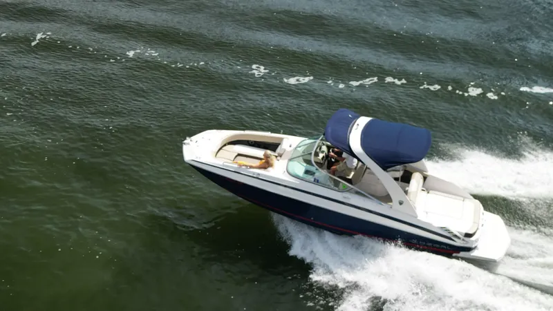 Slide: The Image of 2014 Regal 2700 Bowrider cruising on open water. - 4