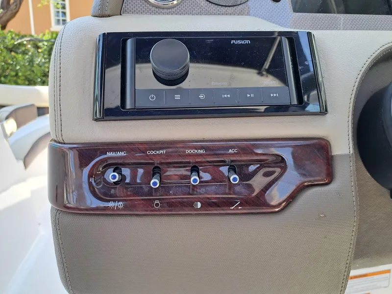 Slide: The Image of Control panel of a 2014 Regal 2700 Bowrider boat with Fusion audio system. - 41