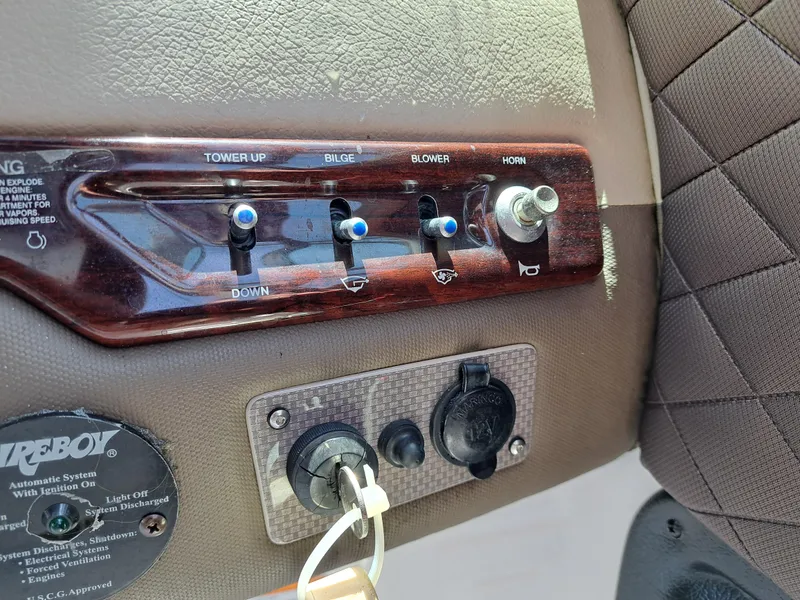 Slide: The Image of Control panel of a 2014 Regal 2700 Bowrider boat with switches and key ignition. - 42