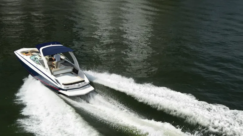 Slide: The Image of 2014 Regal 2700 Bowrider speeding on water, creating waves. - 5