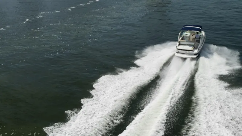 Slide: The Image of 2014 Regal 2700 Bowrider speeding on open water, leaving a wake trail. - 6