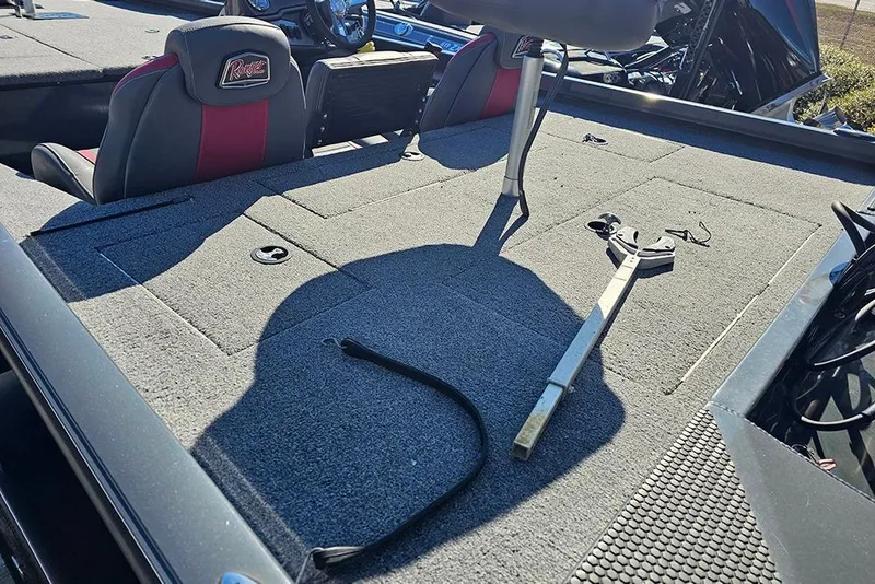 Slide: The Image of 2022 Ranger RT188 boat interior with seats, carpeted deck, and fishing rod holder. - 10