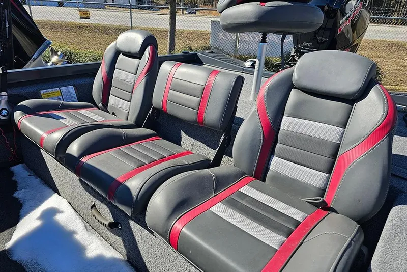 Slide: The Image of 2022 Ranger RT188 boat seats with black and red upholstery, parked outdoors. - 12