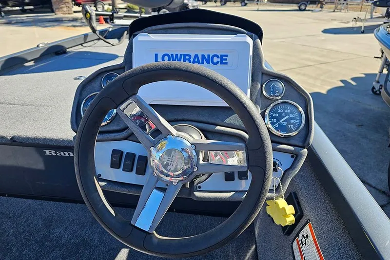 Slide: The Image of 2022 Ranger RT188 boat dashboard with steering wheel and Lowrance display. - 13