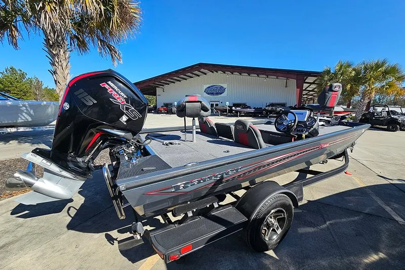 Slide: The Image of 2022 Ranger RT188 boat with Mercury Pro XS engine, parked outdoors under clear blue sky. - 4