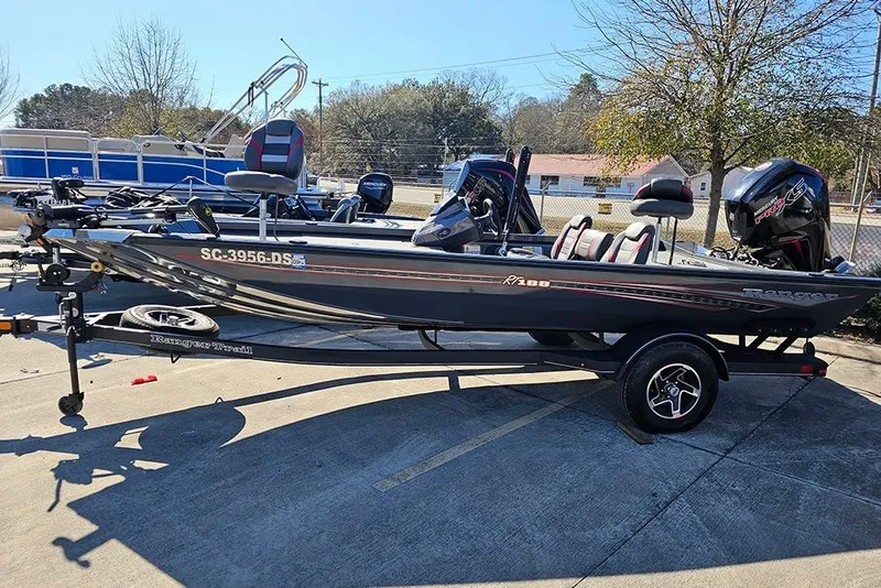 Slide: The Image of 2022 Ranger RT188 fishing boat on trailer, parked outdoors in sunny weather. - 7