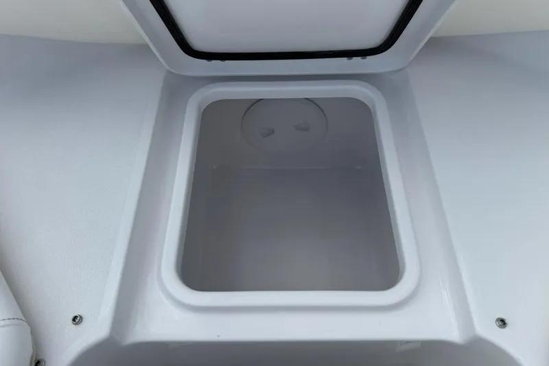Slide: The Image of Open storage compartment on 2026 Sportsman Heritage 261 Center Console boat. - 11