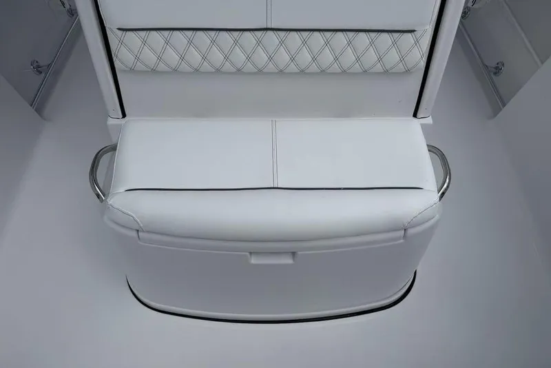 Slide: The Image of White seating on 2026 Sportsman Heritage 261 Center Console boat, featuring diamond-patterned upholstery. - 13