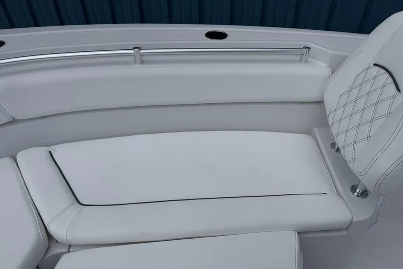 Slide: The Image of 2026 Sportsman Heritage 261 Center Console boat with white cushioned seating. - 14