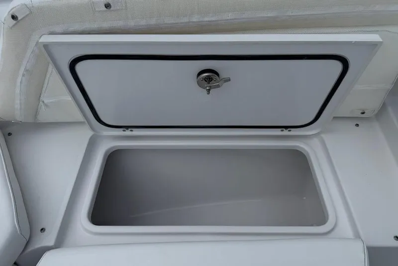 Slide: The Image of Open storage compartment on 2026 Sportsman Heritage 261 Center Console boat. - 15