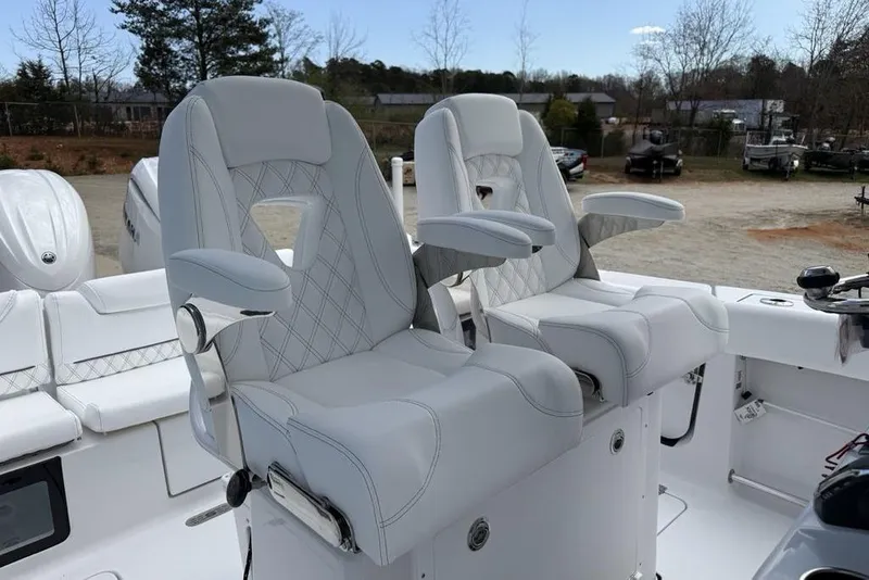 Slide: The Image of 2026 Sportsman Heritage 261 Center Console boat with luxurious dual captain's chairs. - 17