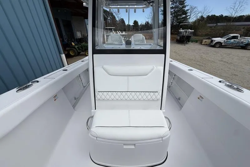 Slide: The Image of 2026 Sportsman Heritage 261 Center Console boat interior with white seating and console. - 19
