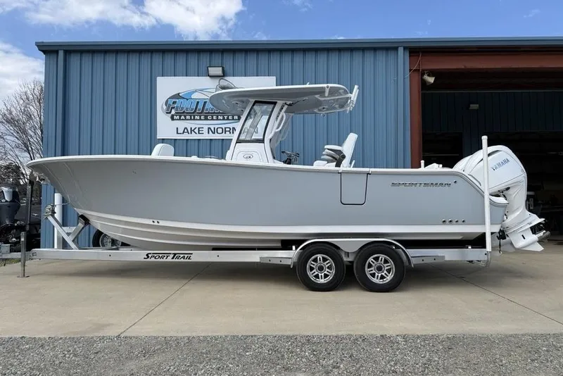 The Image of 2026 Sportsman Heritage 261 Center Console boat on trailer at marine center. - 2