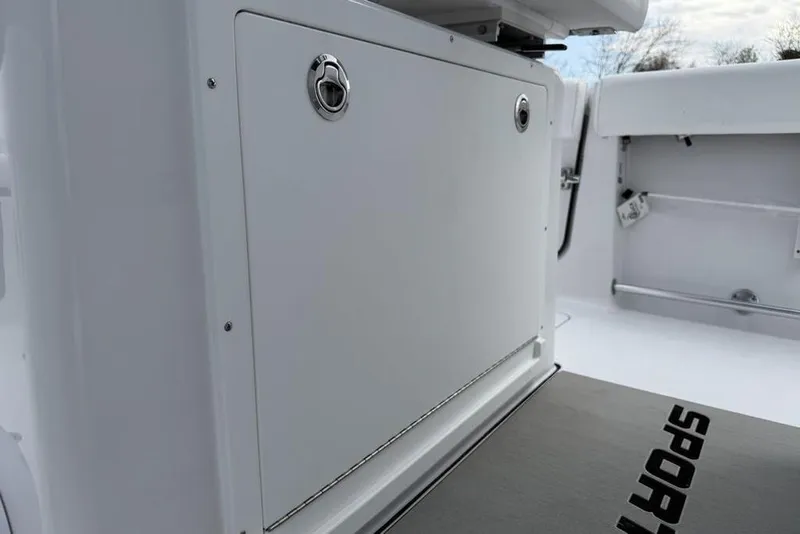 Slide: The Image of 2026 Sportsman Heritage 261 Center Console interior, featuring storage compartment and deck details. - 23